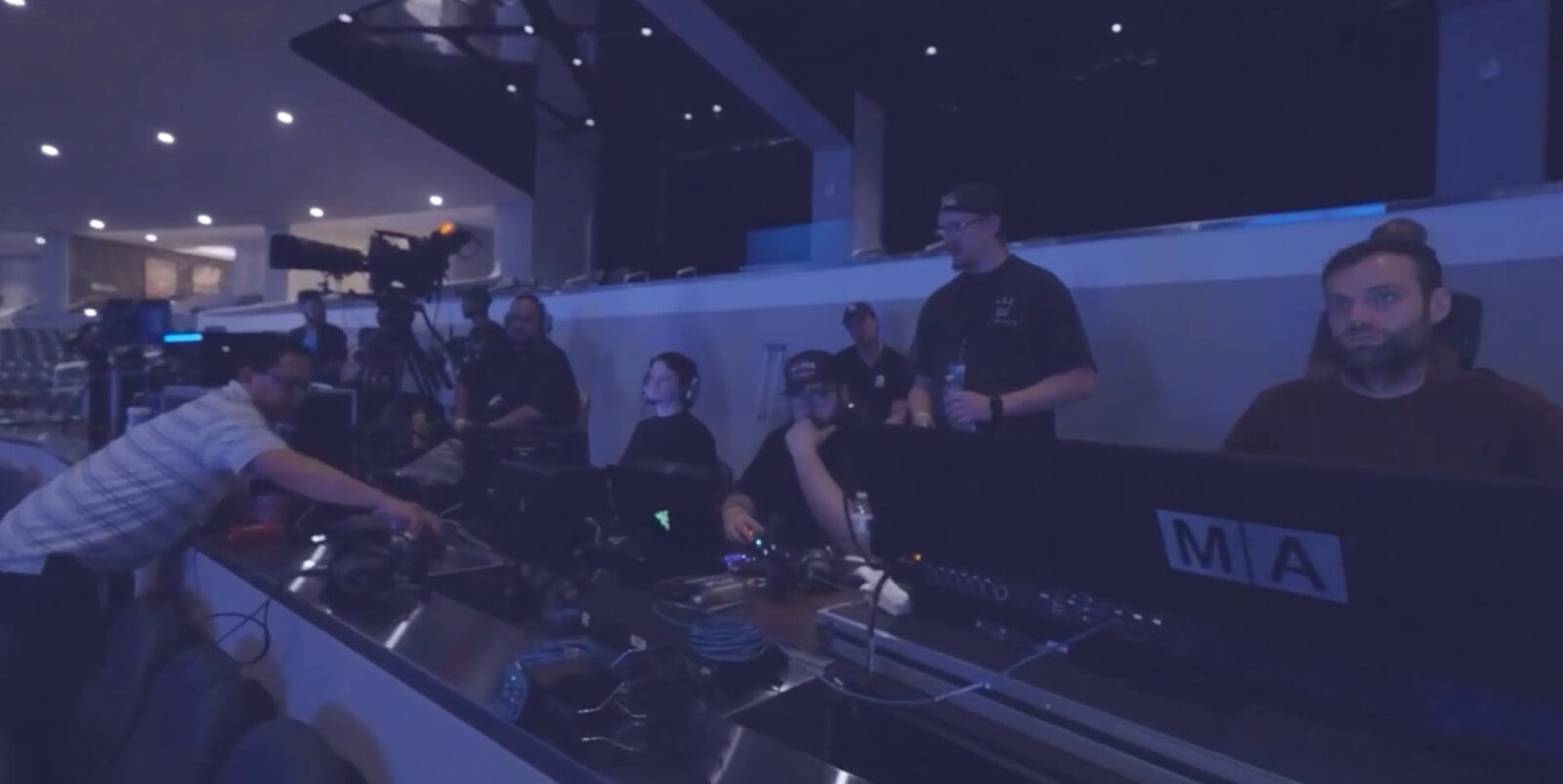Lighting and video operators at the front-of-house console during a live show.