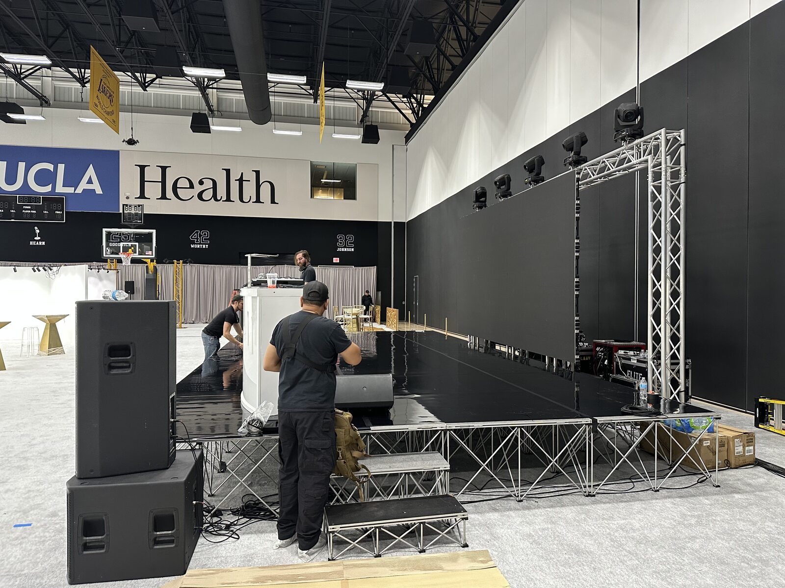 Stage and LED video wall build · truss, PA stacks and moving light rigged for In The Paint.