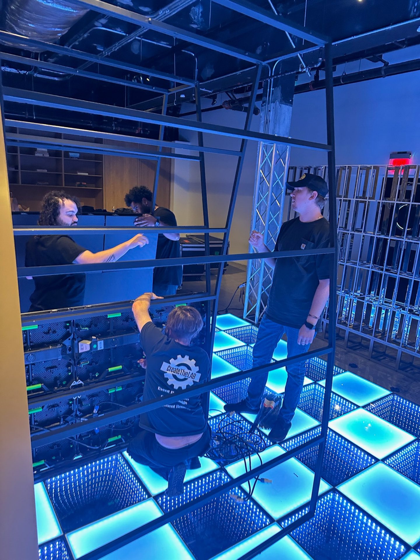 Behind the arches · Create TheLAB crew assembling the LED environment.